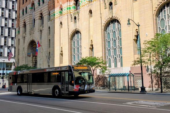 A SMART bus passing the Guardian Building downtown during afternoon rush hour