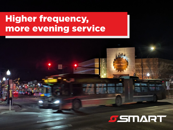 An articulated FAST bus traveling south through downtown Ferndale at night